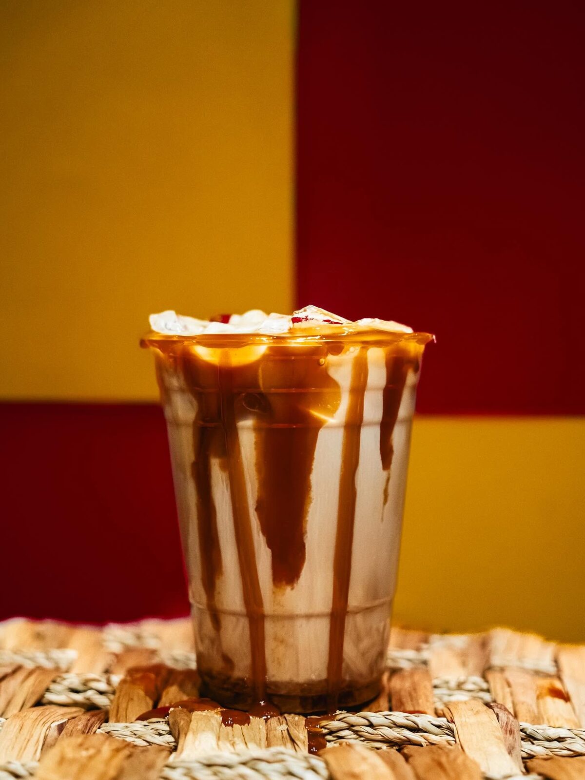 Iced latte with caramel sauce streaked down the cup