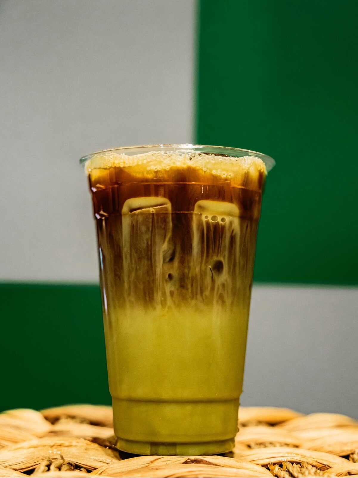 Layered iced drink with espresso over a green matcha base